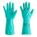 A pair of green Ansell AlphaTec Solvex rubber gloves with a number on them.