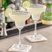 Two glasses of Zing Zang Margarita Mix with lime wedges on the rim.