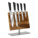 A Mercer Culinary Damascus knife set on a wooden stand with knives.