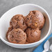 A bowl of Eclipse Foods chocolate ice cream with a scoop on top.