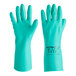 A pair of green Ansell Solvex nitrile gloves with cotton lining.