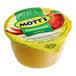 A close-up of a yellow Mott's applesauce cup with a green label.