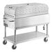 A large stainless steel Backyard Pro grill on wheels.