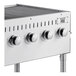 A stainless steel Backyard Pro outdoor grill with four burners and knobs.
