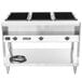 A stainless steel Vollrath electric hot food table with three square black containers.