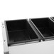 A Vollrath ServeWell electric hot food table with open black containers inside.