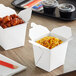 Two Emperor's Select white microwavable take-out containers filled with food on a table.