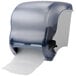 A San Jamar paper towel dispenser in arctic blue with a white roll of paper.