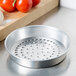 An American Metalcraft silver aluminum round pan with holes in it.