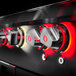 The black and red Crown Verity built-in side burners with red knobs.