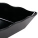 A black rectangular Milano melamine tray with a wavy edge.
