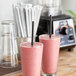 Two glasses of pink smoothies with Aardvark black wrapped paper straws.