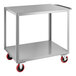 A silver metal cart with red wheels.