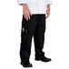 A person wearing Chef Revival black cargo pants and a white chef coat.