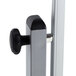 A close-up of a metal pole attached to a whiteboard with an aluminum frame.