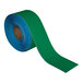 A roll of green and blue Superior Mark safety tape.