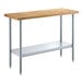 A wood table with a galvanized metal base and adjustable metal undershelf.