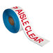 A roll of white tape with red text reading "Keep Aisle Clear"