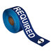 A blue roll of Superior Mark safety tape with white "Safety Glasses Required" text.