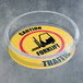 A clear circular floor sign protector with a forklift caution sign in it.
