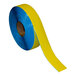 A roll of yellow and blue Superior Mark safety floor tape.