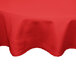 A red Intedge round tablecloth on a white table.