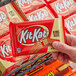 A person holding a KIT KAT King Size Milk Chocolate Bar package.