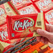 A person holding a KIT KAT King Size Milk Chocolate Bar