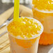 A cup of orange drink with a Fanale Mango Star-Shaped Jelly topping and a yellow straw.