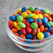 A bowl of colorful chocolate rainbow gems.