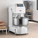 A large commercial spiral dough mixer with a stainless steel bowl and control panel, designed for heavy-duty bakery use.