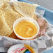 A bowl of Land O Lakes cheddar cheese dip with tortilla chips.