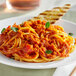 A white plate of spaghetti with Red Gold Bolognese sauce and toasted bread.