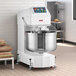 An industrial two-speed spiral dough mixer with a large stainless steel bowl and control panel, designed for commercial bakery use.
