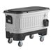 A large white and black Igloo cooler on wheels.