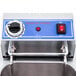A Globe electric countertop fryer on a counter with a blue and white button.