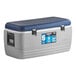 An Igloo Maxcold outdoor cooler with grey sides and a blue lid.