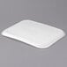 A white rectangular Huhtamaki Chinet molded fiber tray on a gray surface.