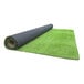 A roll of FloorEXP synthetic grass with black rubber underneath.