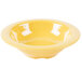 A close up of a yellow GET Diamond Mardi Gras melamine bowl with a white line.