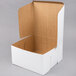A white cardboard bakery box with a lid.