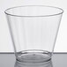 A WNA Comet clear plastic fluted tumbler on a white table.
