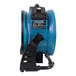 A close up of a blue and black XPOWER portable air circulator.
