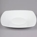 A white square porcelain plate with a coupe shape.