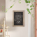 A Flash Furniture wall mount chalkboard with the words 'i love to laugh' written on it.
