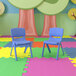 A pair of blue Flash Furniture Whitney plastic chairs on a colorful floor.