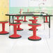 A group of Flash Furniture red stools with black legs.