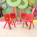 A group of Flash Furniture red plastic stackable chairs in a colorful room.
