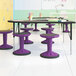 A group of purple Flash Furniture kid's adjustable stools.