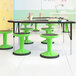 A group of Flash Furniture green kid's adjustable stools with black legs.